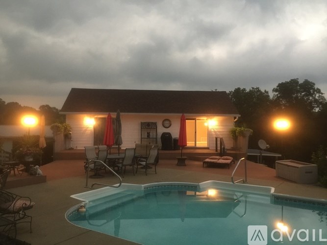 A pool in a backyard with a house in the background.