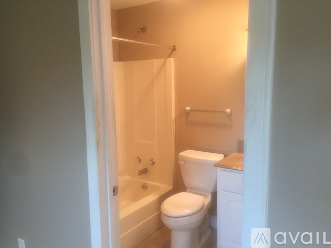 A bathroom with a toilet, sink, and bathtub.