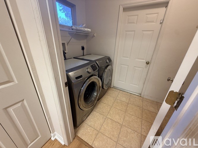 A small laundry room with a washer and dryer.
