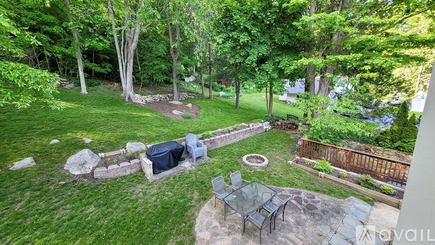 A backyard with a fire pit and a hot tub.