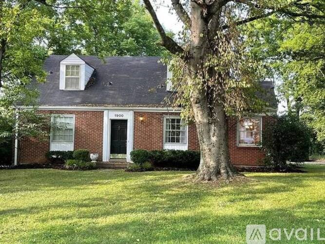 A house with a tree in front of it.