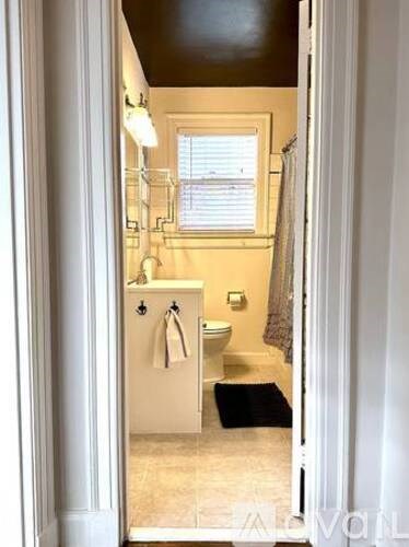 A bathroom with a toilet, sink, and shower.