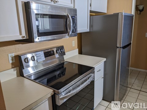 A kitchen with a stainless steel oven and microwave.
