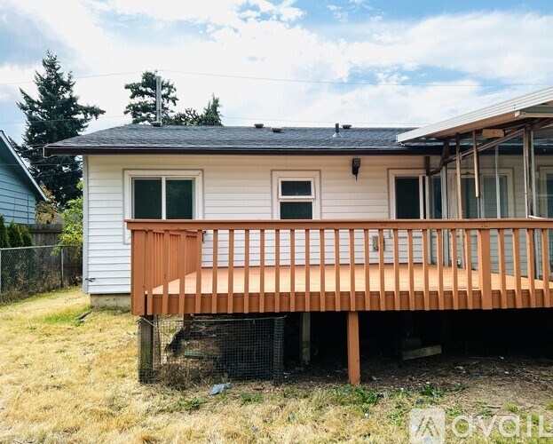 A house with a wooden deck is for sale.