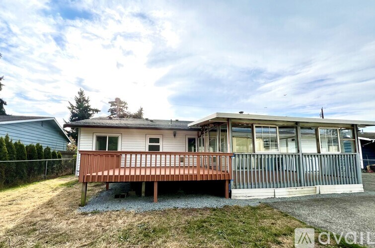 A house with a red deck is for sale.
