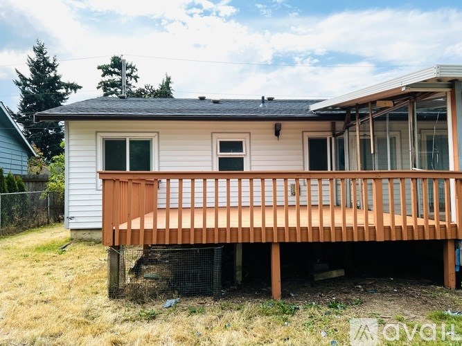 A house with a wooden deck in front.