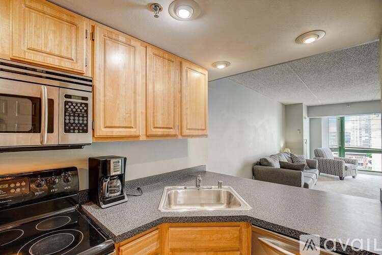 A kitchen with wooden cabinets and a black stove top oven.