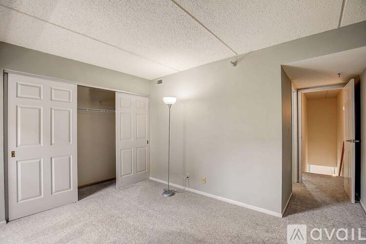 A room with a carpeted floor and a white door.