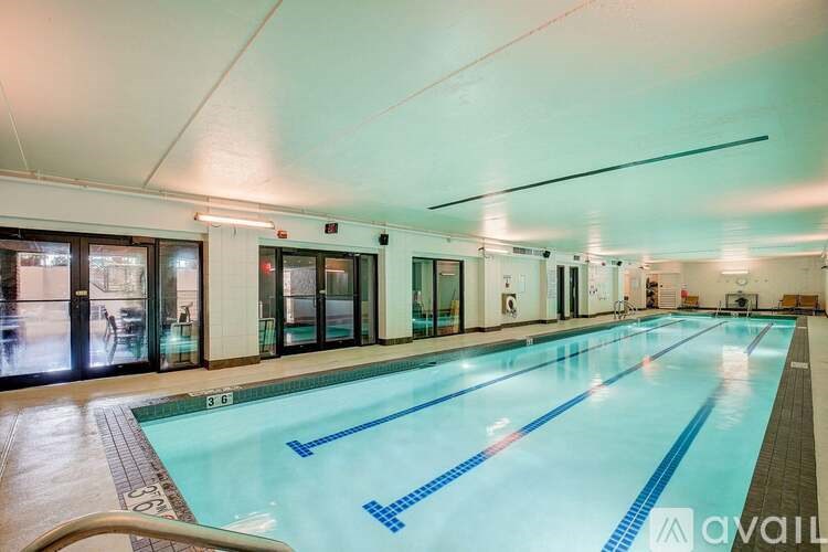 A large indoor swimming pool with lanes marked in blue.