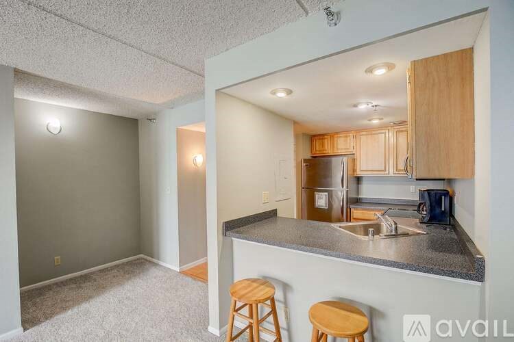 A kitchen area with a bar stool and a countertop.
