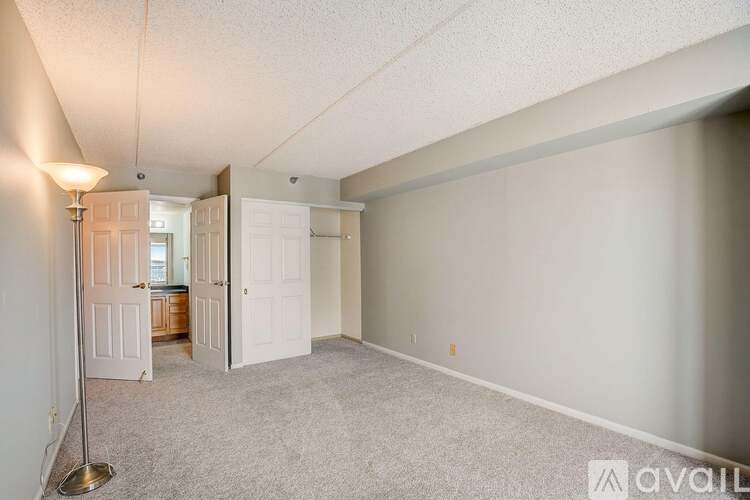 A room with a carpeted floor and a lamp post.