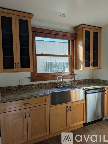 A kitchen with wooden cabinets and granite countertops.