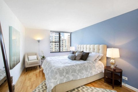 a bedroom with a large bed and a large window