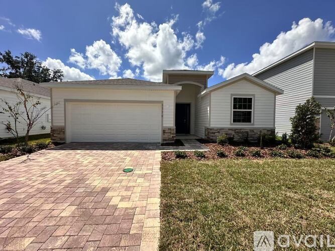 A house with a garage door and a driveway.
