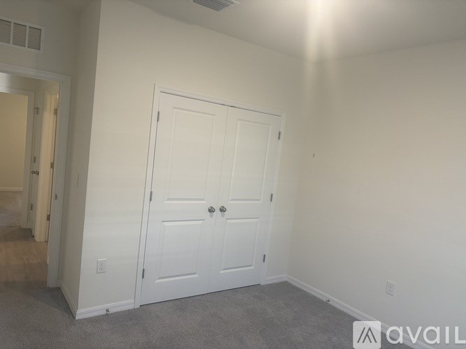 A kitchen with a granite countertop and a stainless steel dishwasher.