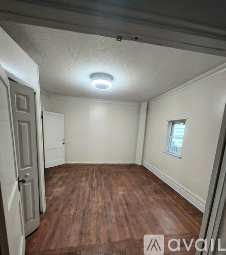A room with wooden floors and a window.