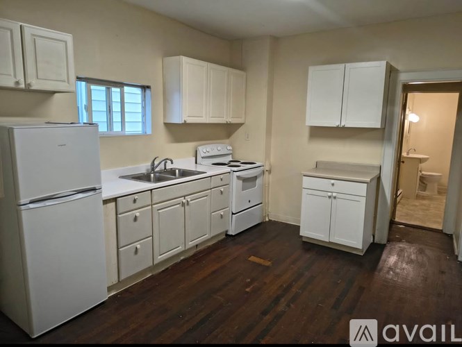 A kitchen with white appliances and cabinets.