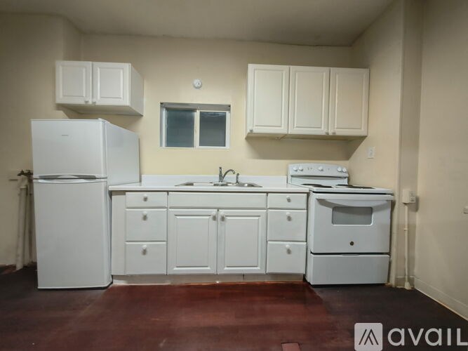 A kitchen with white appliances and cabinets.