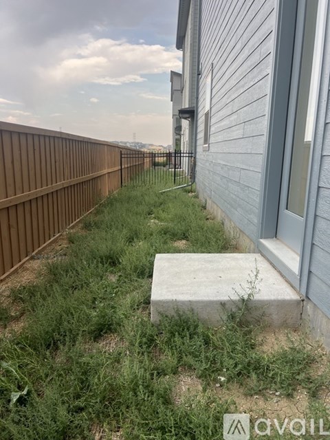 A concrete block is on the ground next to a house.
