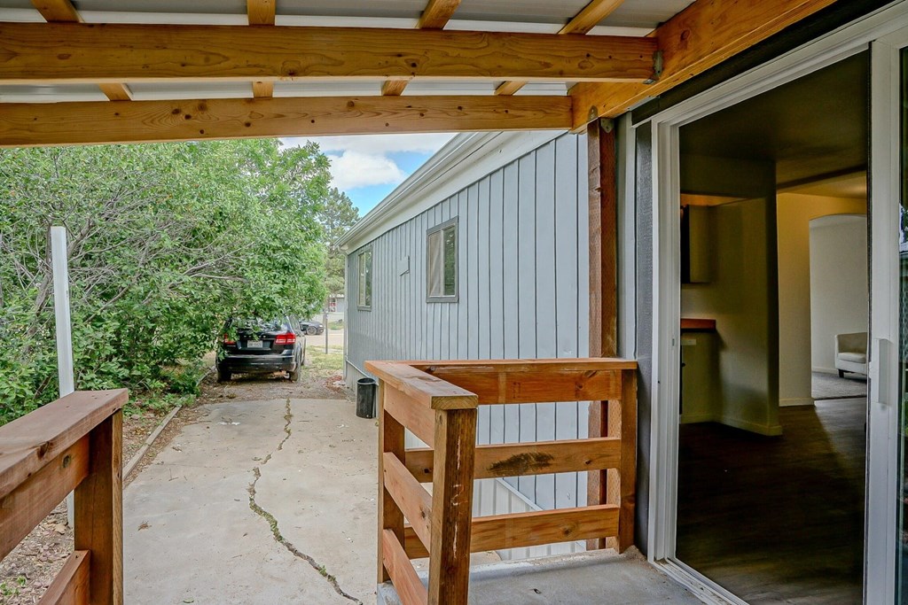 A car is parked in the driveway of a house.