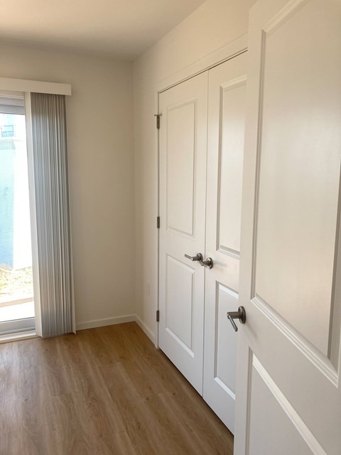 A white door with a black handle is on the right side of the image.