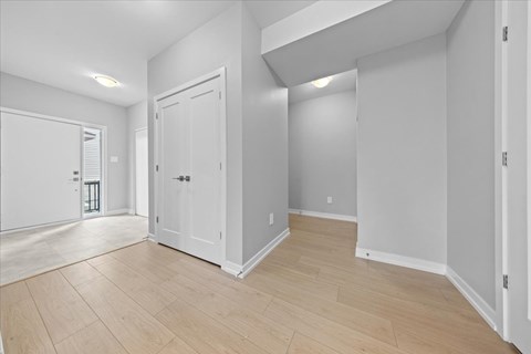 A room with a white door and a white wall.