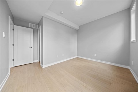 A room with a white door and a window.