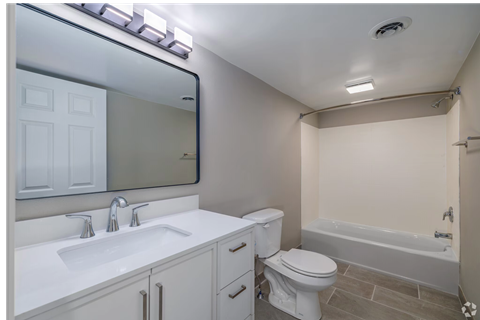 A white bathroom with a sink, toilet, and bathtub.