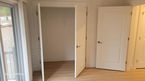 A room with a white door and a white wall.