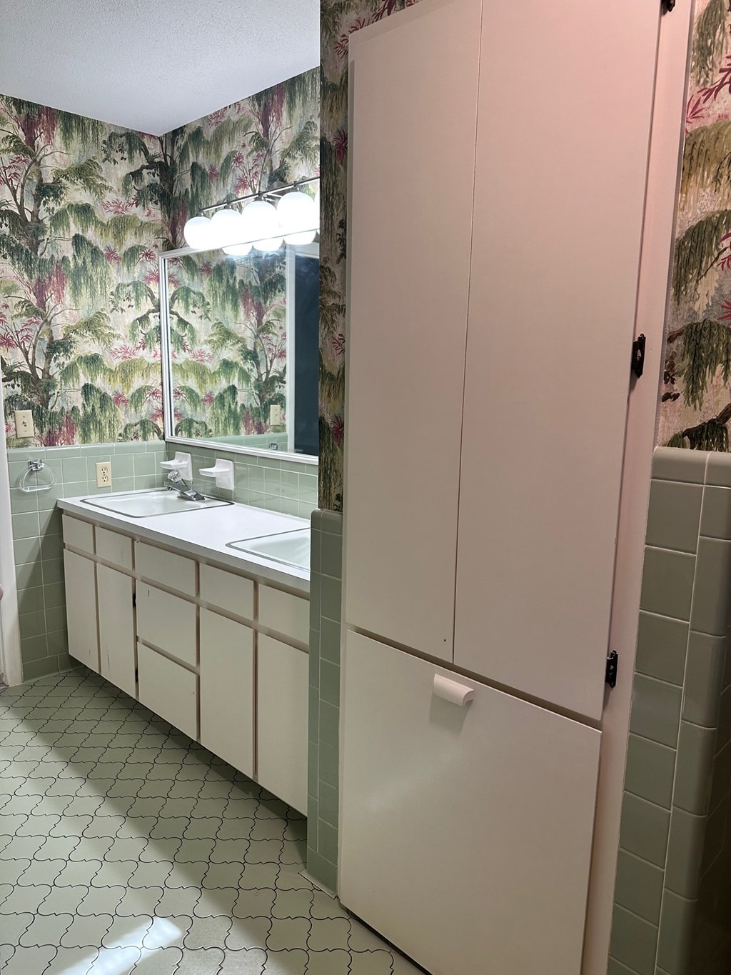 A bathroom with a sink and a cabinet.