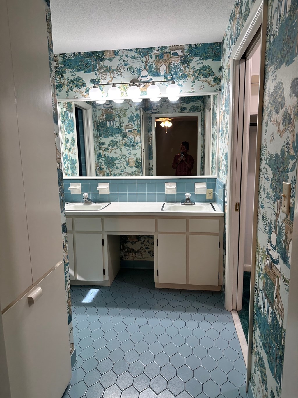 A bathroom with a mirror and a sink.