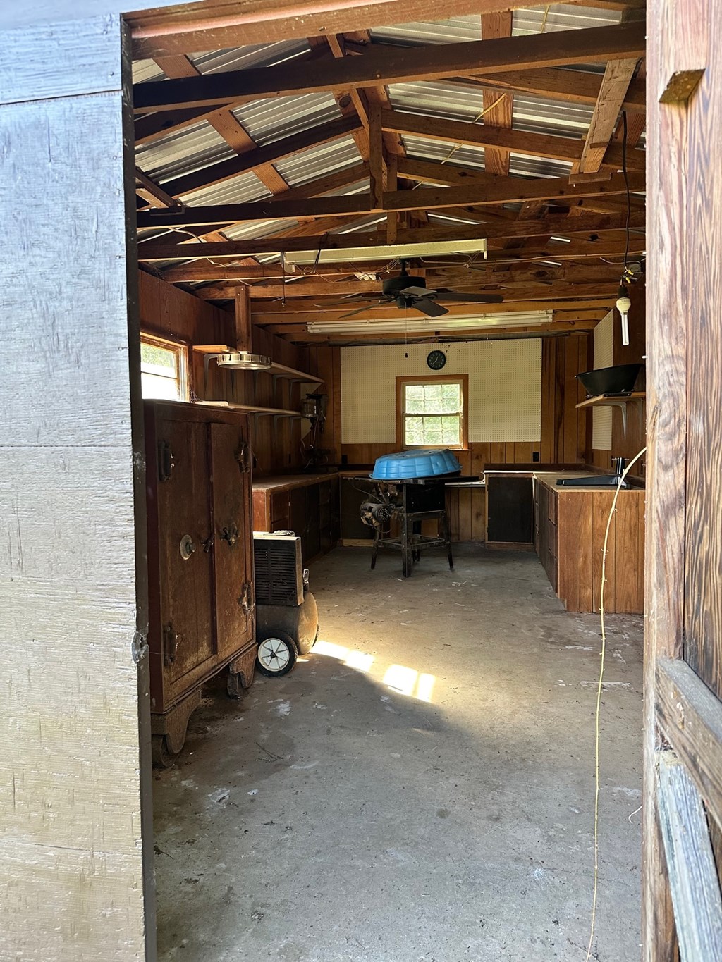 A room with a fan and a window.