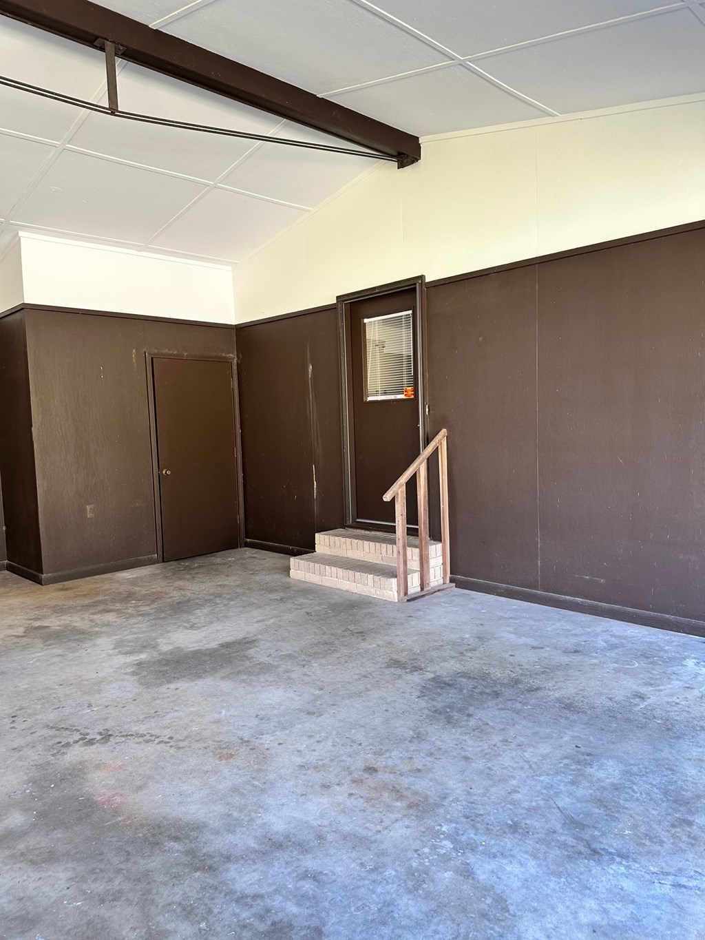A room with brown walls and a concrete floor.