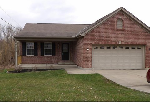A red brick house with a white garage door.