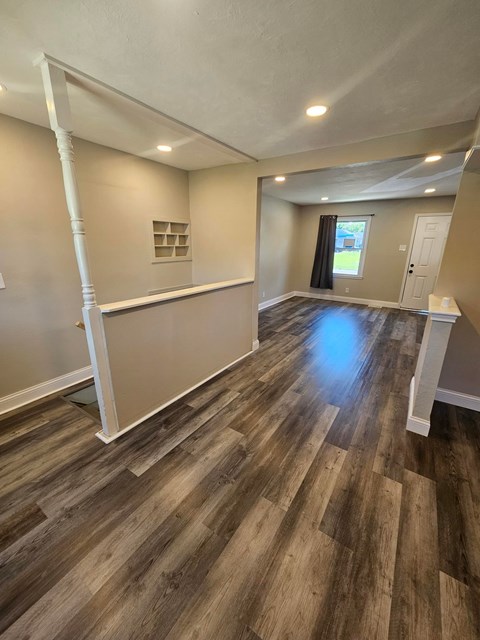 A room with wooden flooring and white trim.