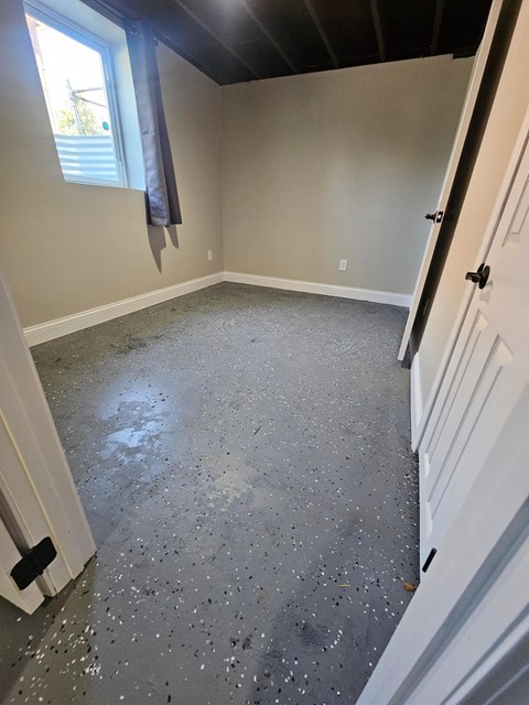 A room with a grey floor and white walls.