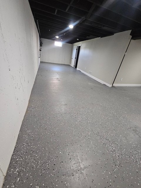 A long hallway with a door at the end.