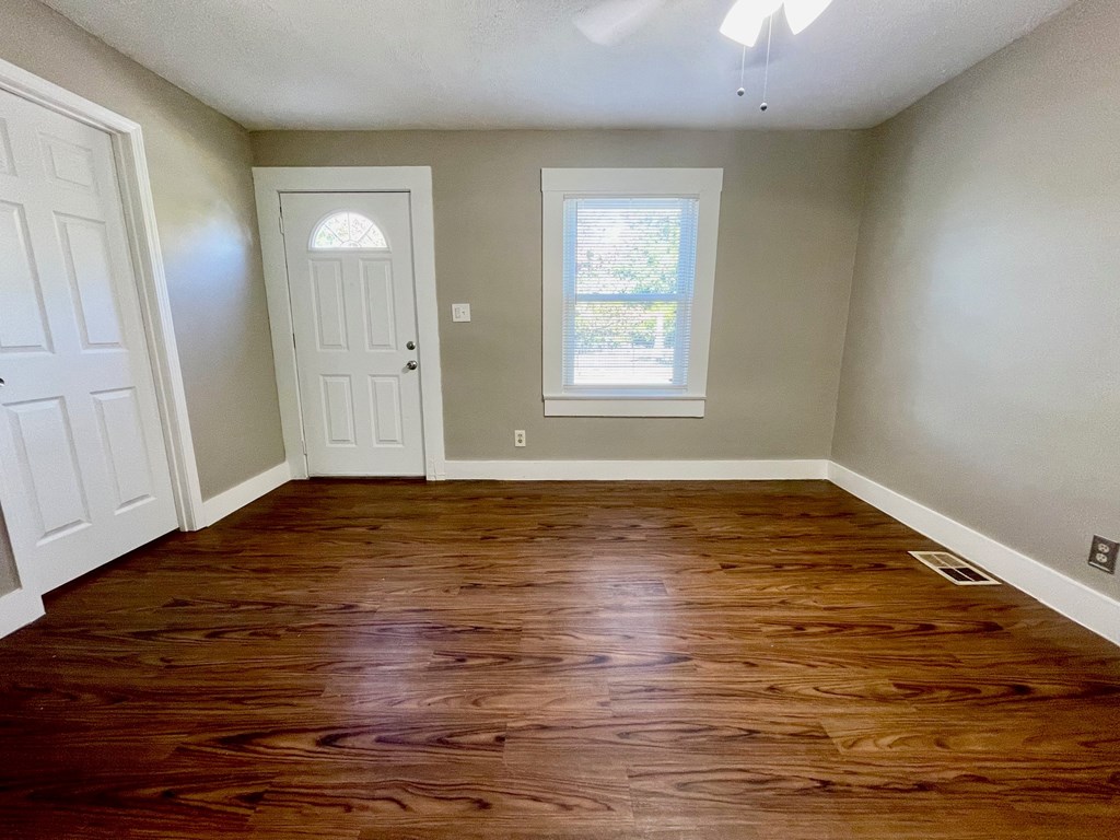 A room with wooden floors and a window.