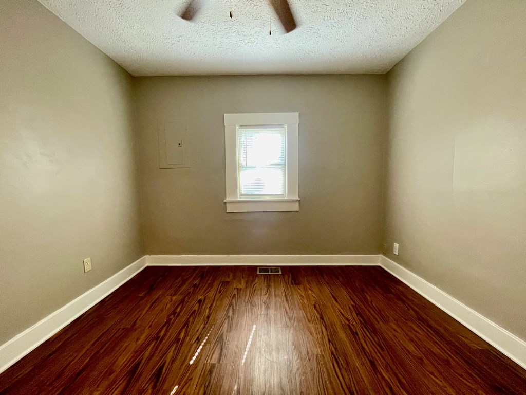 A room with wooden floors and a window.
