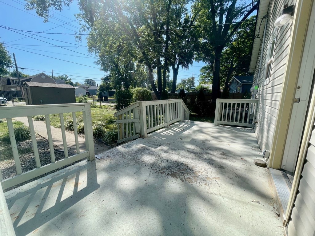 A sunny day at a residential area with a white fence.
