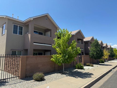 A row of houses with a clear blue sky above them.