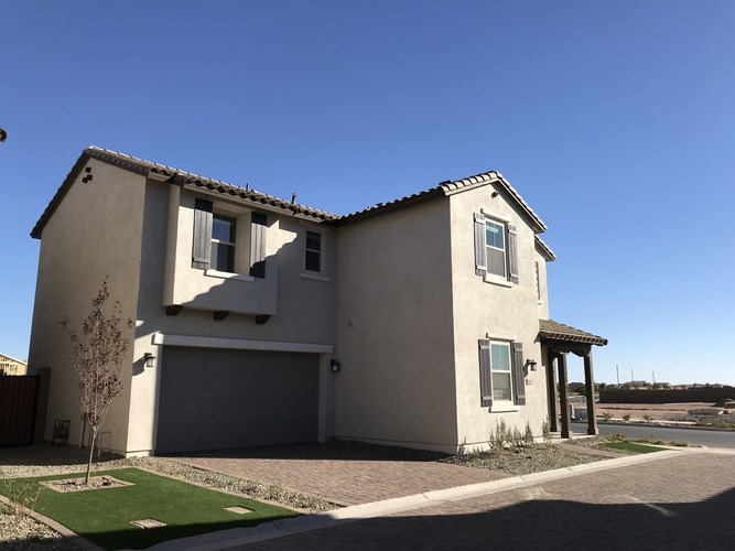 A two-story house with a garage and a covered entryway.
