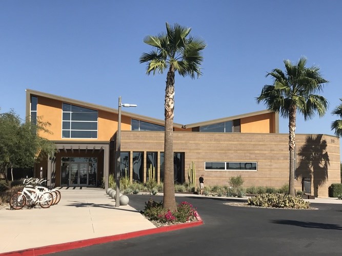 A modern building with a red walkway in front.