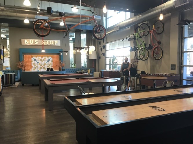 A room with tables and a sign that says Bus Stop.