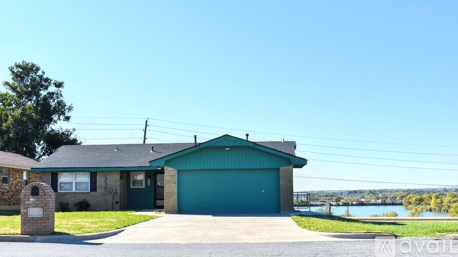 A house with a green garage door is for sale.