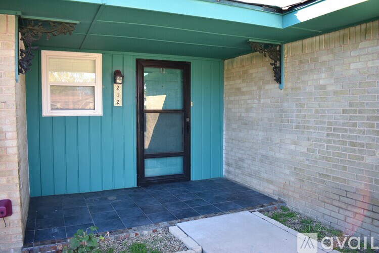 A blue house with a glass door and a window.