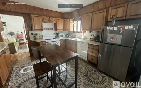 A kitchen with a table and chairs in the middle of the room.