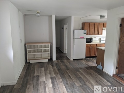A kitchen with a white fridge and wooden cabinets.