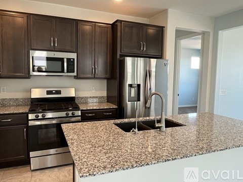 A kitchen with granite countertops and stainless steel appliances.