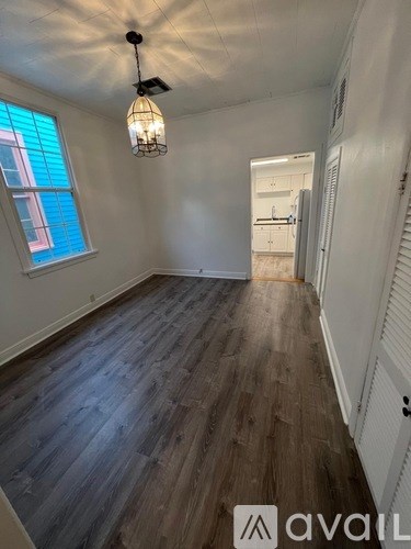 A room with wooden flooring and a ceiling fan.